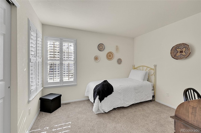 bedroom with carpet floors, visible vents, and baseboards