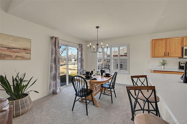 dining area with light carpet, baseboards, and an inviting chandelier