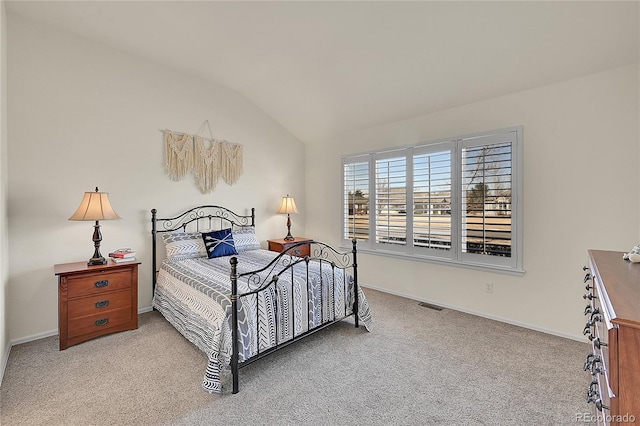 bedroom featuring vaulted ceiling, light carpet, visible vents, and baseboards