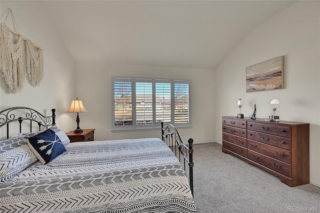 bedroom featuring lofted ceiling and carpet