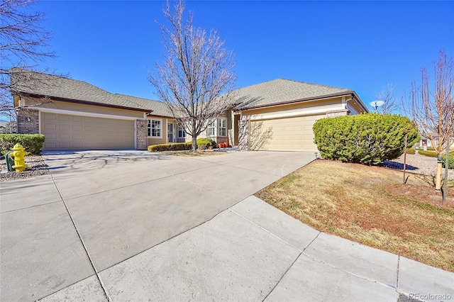 ranch-style house with concrete driveway and an attached garage