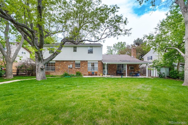 9540 E Grand Pl, Greenwood Village, CO 80111 - rear view of house with a patio, brick siding, and a chimney