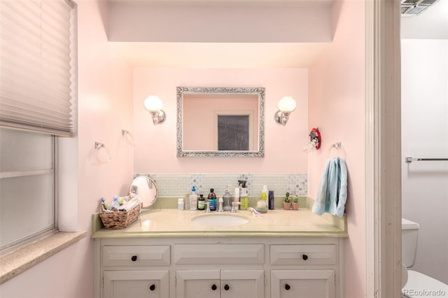 9540 E Grand Pl, Greenwood Village, CO 80111 - bathroom featuring vanity, backsplash, and toilet