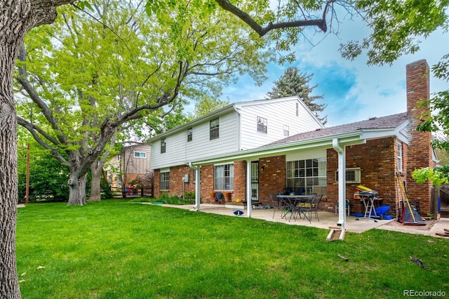 9540 E Grand Pl, Greenwood Village, CO 80111 - back of house with brick siding, a patio, and a chimney