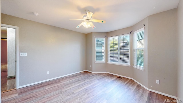 15926 Butterwort Cir, Parker, CO 80134 - spare room featuring wood finished floors, ceiling fan, and a smoke detector