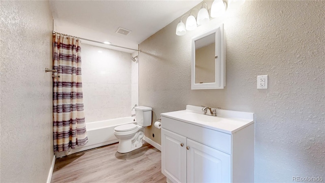 15926 Butterwort Cir, Parker, CO 80134 - full bathroom with a textured wall, vanity, shower / bath combo with shower curtain, and wood finished floors