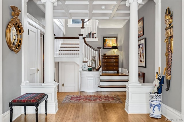 entrance foyer featuring ornamental molding, coffered ceiling, beamed ceiling, and hardwood / wood-style flooring