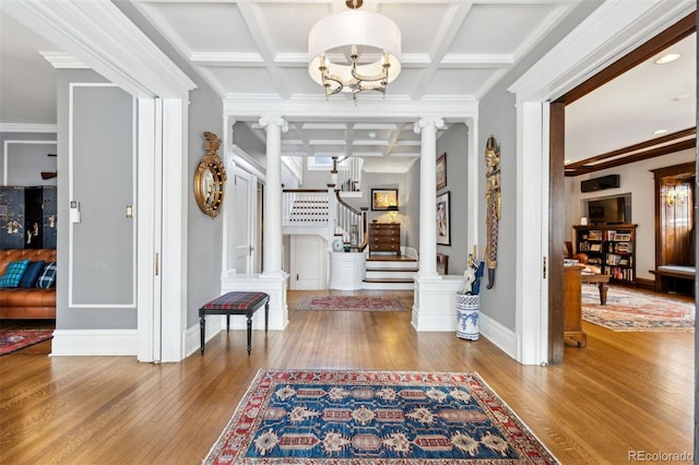 entrance foyer with decorative columns, ornamental molding, hardwood / wood-style flooring, coffered ceiling, and beam ceiling