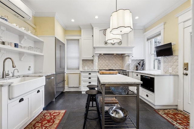 kitchen featuring light stone countertops, pendant lighting, white cabinets, appliances with stainless steel finishes, and a wall mounted air conditioner