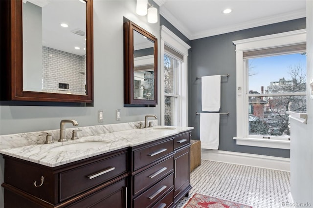 bathroom with ornamental molding and vanity