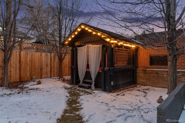 snow covered structure featuring a gazebo