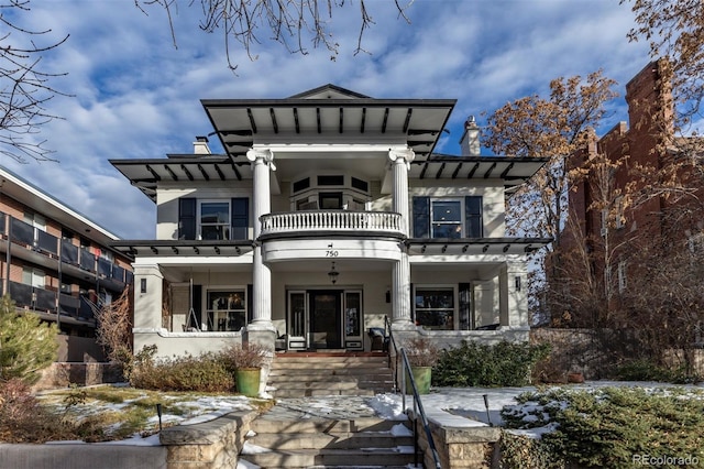 rear view of house featuring a porch and a balcony