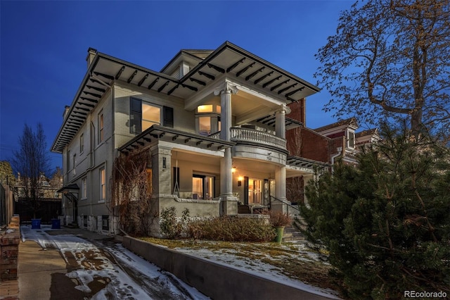 exterior space featuring a balcony and covered porch