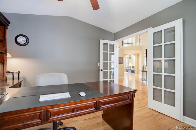 office area featuring vaulted ceiling, ceiling fan, french doors, and light wood-type flooring