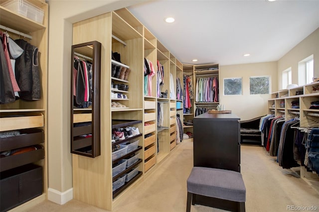 walk in closet featuring light colored carpet