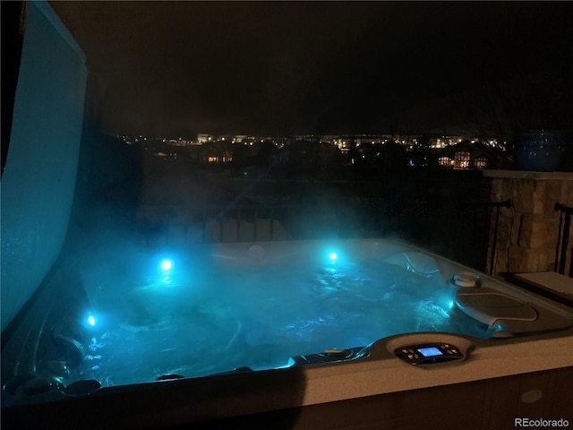 view of pool at twilight
