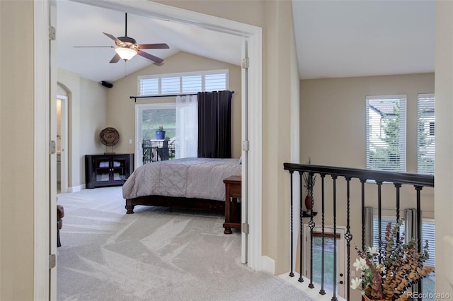 bedroom with carpet floors, lofted ceiling, multiple windows, and access to exterior