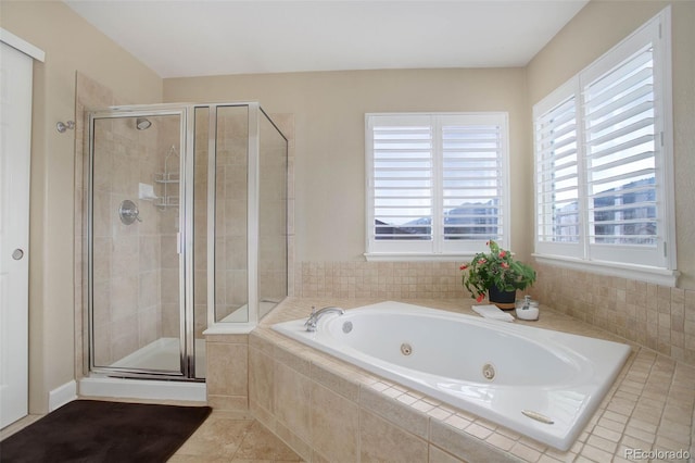 bathroom featuring a jetted tub, tile patterned flooring, and a stall shower