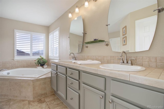 full bathroom with a garden tub, a sink, and double vanity