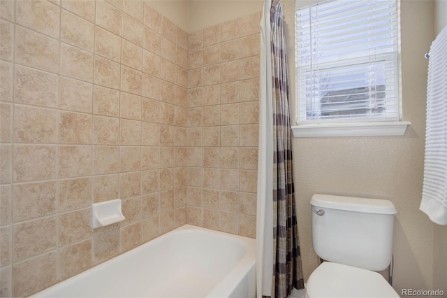 full bathroom featuring toilet and shower / bathtub combination with curtain