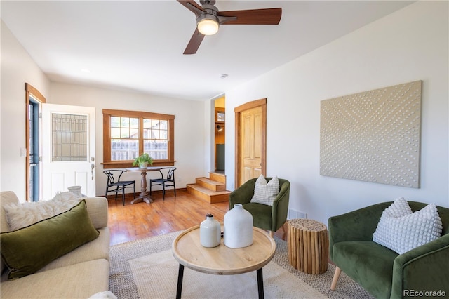 living area featuring wood finished floors and ceiling fan