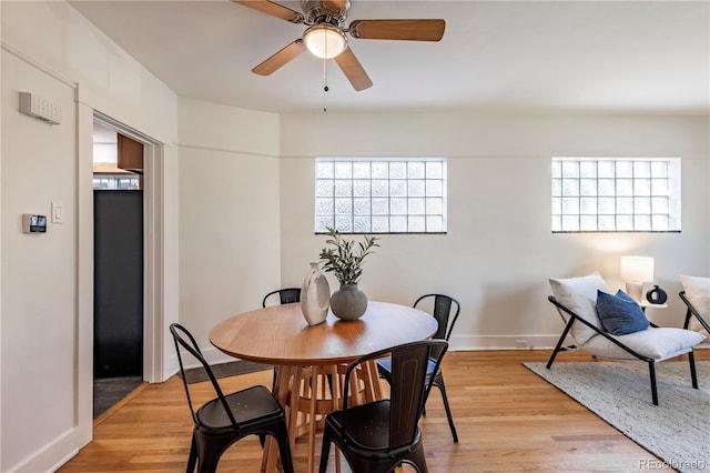 dining area with a ceiling fan, light wood-style flooring, and healthy amount of natural light