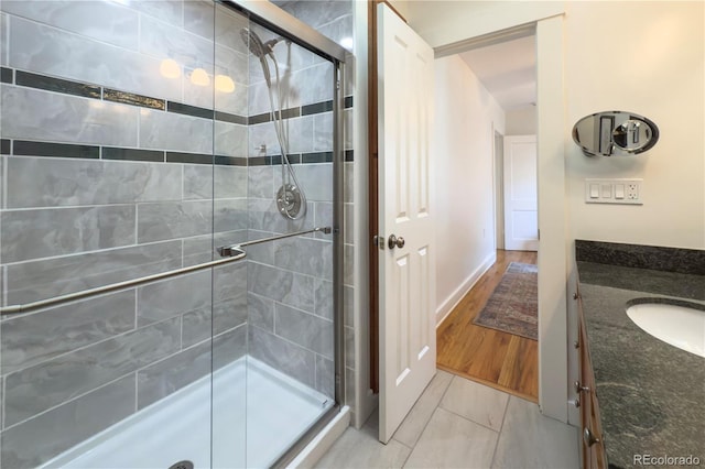 bathroom with a stall shower and vanity