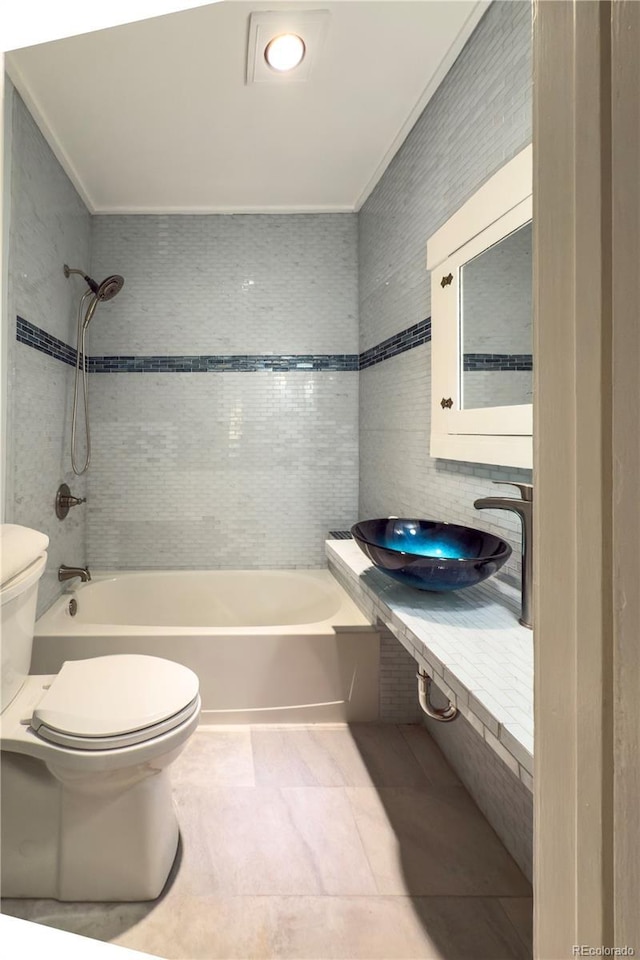 full bathroom featuring toilet, a sink, bathtub / shower combination, tile patterned flooring, and ornamental molding