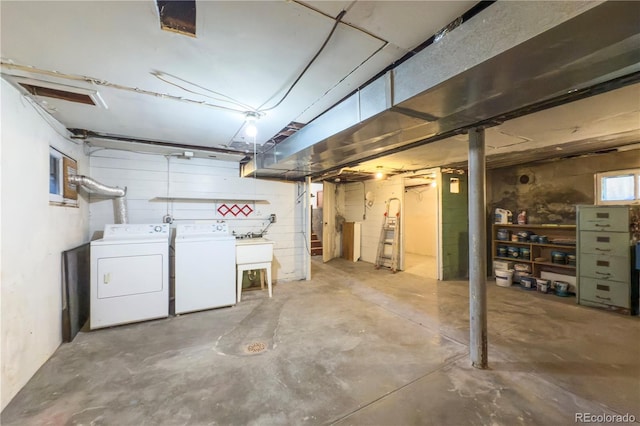 unfinished basement with washer and clothes dryer and a sink