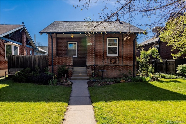 bungalow featuring brick siding, covered porch, and a shingled roof