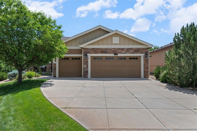 15414 Xenia Ct, Thornton, CO 80602 - craftsman house with stone siding, driveway, board and batten siding, a front yard, and a garage