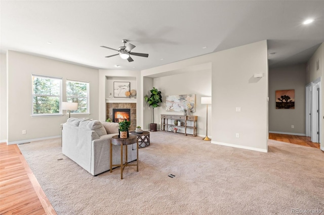 15414 Xenia Ct, Thornton, CO 80602 - living room featuring ceiling fan, a fireplace, and light wood finished floors