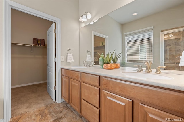 15414 Xenia Ct, Thornton, CO 80602 - full bathroom featuring double vanity, a spacious closet, a shower, and stone finish floors