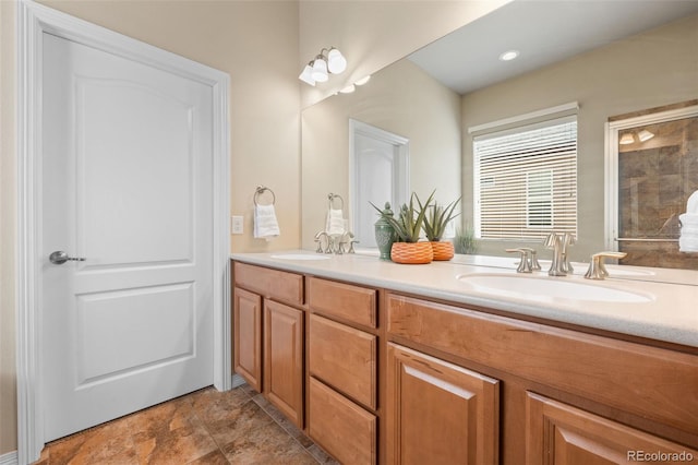 15414 Xenia Ct, Thornton, CO 80602 - bathroom featuring double vanity, stone finish floors, and a shower