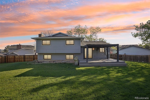 back of property at dusk with a chimney and a wooden deck