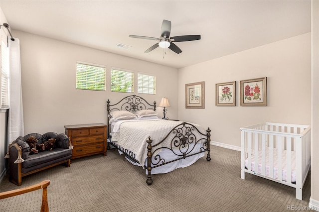 carpeted bedroom featuring a ceiling fan and baseboards