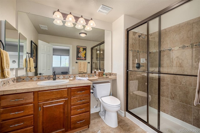 bathroom with a stall shower, tile patterned flooring, toilet, and vanity