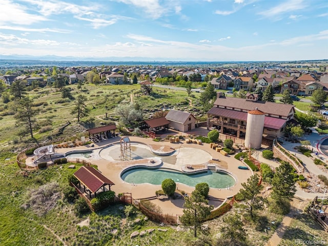 aerial perspective of suburban area featuring a pool