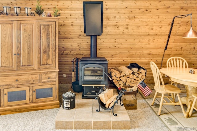 244 Lariat Loop, Hartsel, CO 80449 - living area featuring a wood stove, light colored carpet, and wood walls