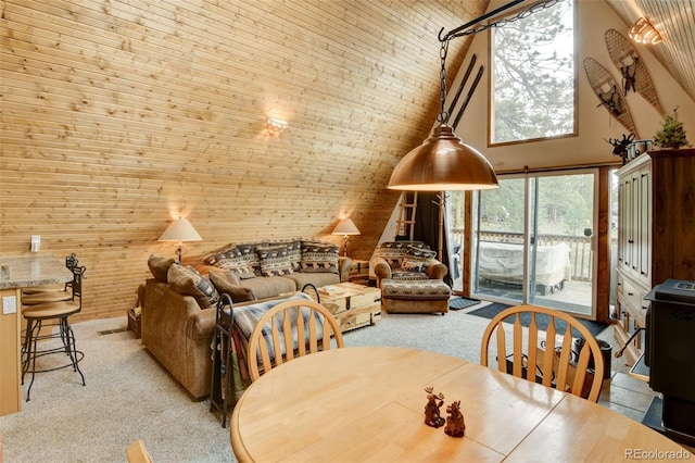 244 Lariat Loop, Hartsel, CO 80449 - dining space with light carpet, wooden walls, and a towering ceiling