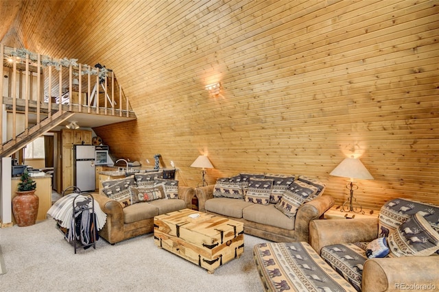 244 Lariat Loop, Hartsel, CO 80449 - living area featuring light colored carpet, wood ceiling, wooden walls, stairway, and high vaulted ceiling