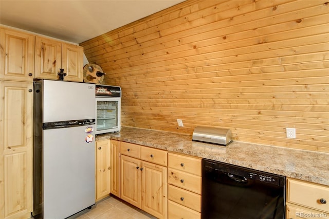 244 Lariat Loop, Hartsel, CO 80449 - kitchen with freestanding refrigerator, black dishwasher, light brown cabinets, wood walls, and light tile patterned floors