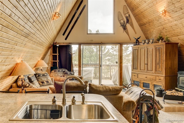 244 Lariat Loop, Hartsel, CO 80449 - kitchen with wood ceiling, high vaulted ceiling, light countertops, carpet flooring, and a wood stove