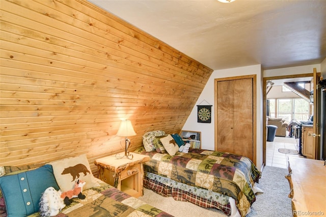 244 Lariat Loop, Hartsel, CO 80449 - bedroom with carpet flooring, vaulted ceiling, wooden walls, and a closet