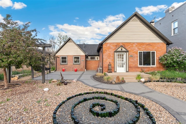 1748 S Logan St, Denver, CO 80210 - view of front of house featuring brick siding and a patio