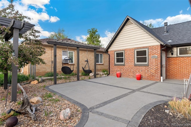 1748 S Logan St, Denver, CO 80210 - rear view of house with brick siding, a pergola, and a patio area