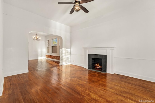 1748 S Logan St, Denver, CO 80210 - unfurnished living room featuring arched walkways, a fireplace, a ceiling fan, a chandelier, and hardwood / wood-style flooring