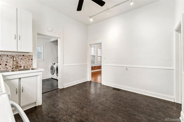1748 S Logan St, Denver, CO 80210 - unfurnished dining area with washer and clothes dryer, ceiling fan, a sink, track lighting, and dark flooring
