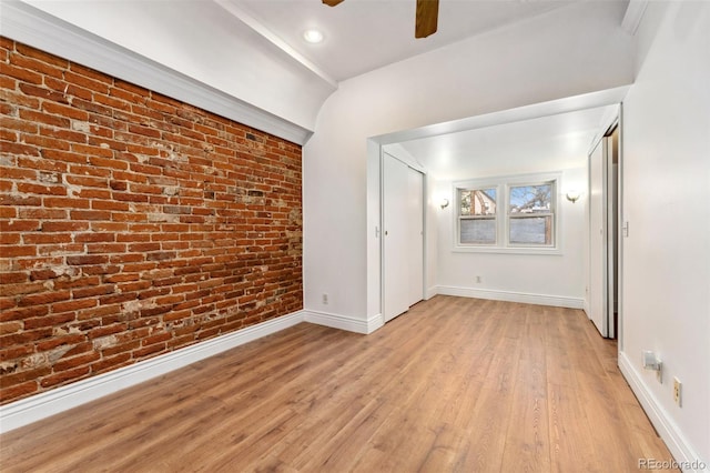 1748 S Logan St, Denver, CO 80210 - spare room with brick wall, a ceiling fan, light wood-style floors, and baseboards