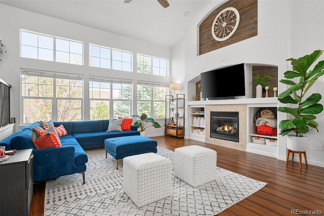 25362 E Indore Dr, Aurora, CO 80016 - living room featuring high vaulted ceiling, a fireplace, wood finished floors, ceiling fan, and plenty of natural light